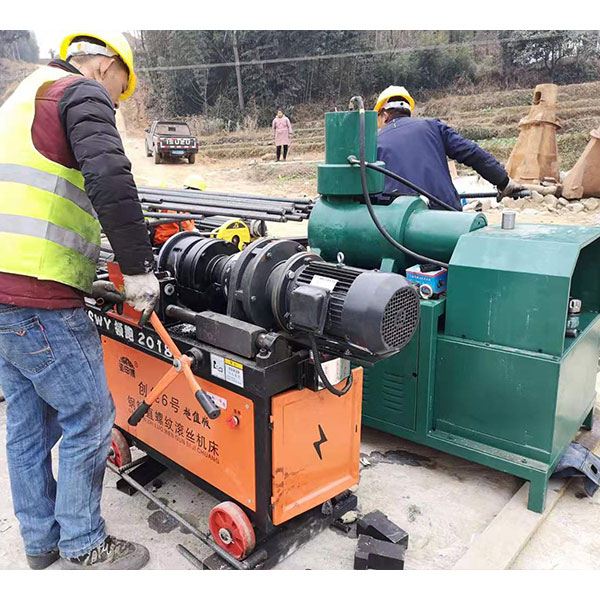 Worker operating the rebar upsetting machine