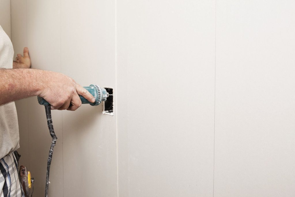 Making clean cuts on SPC wall panels around outlets